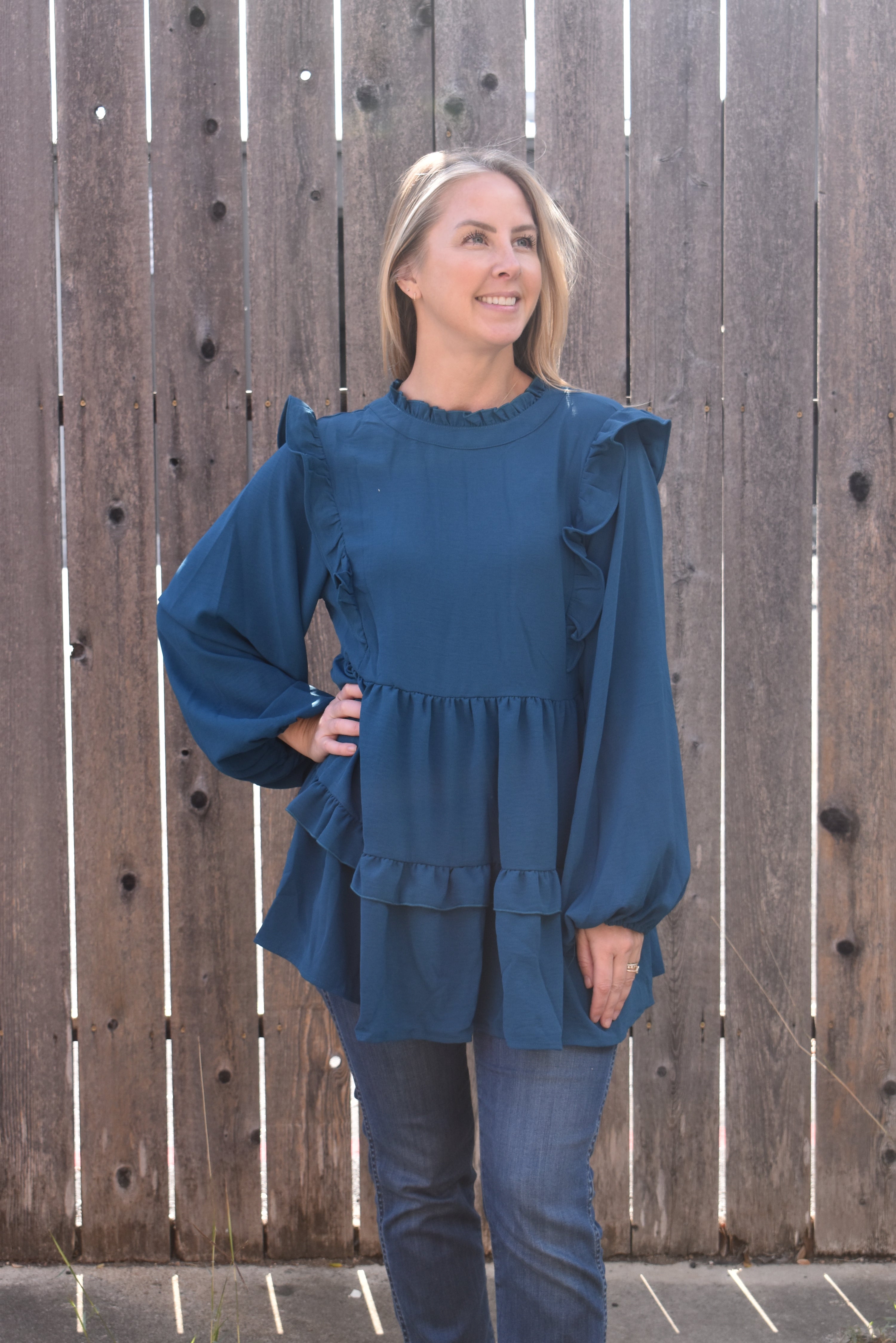 Teal blouse with ruffle long sleeves.