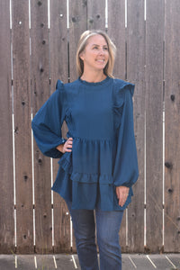 Teal blouse with ruffle long sleeves.