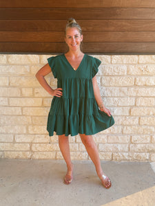 Solid v-neck dress featuring ruffle sleeve.