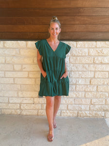 Solid v-neck dress featuring ruffle sleeve.